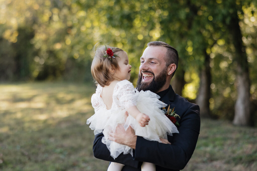 groom kissing his daughter on the cheek
