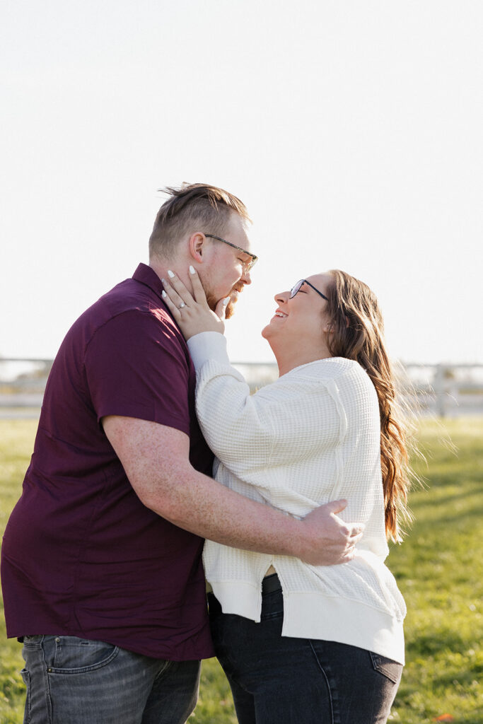 cute couple looking at each other during their engagement photoshoot