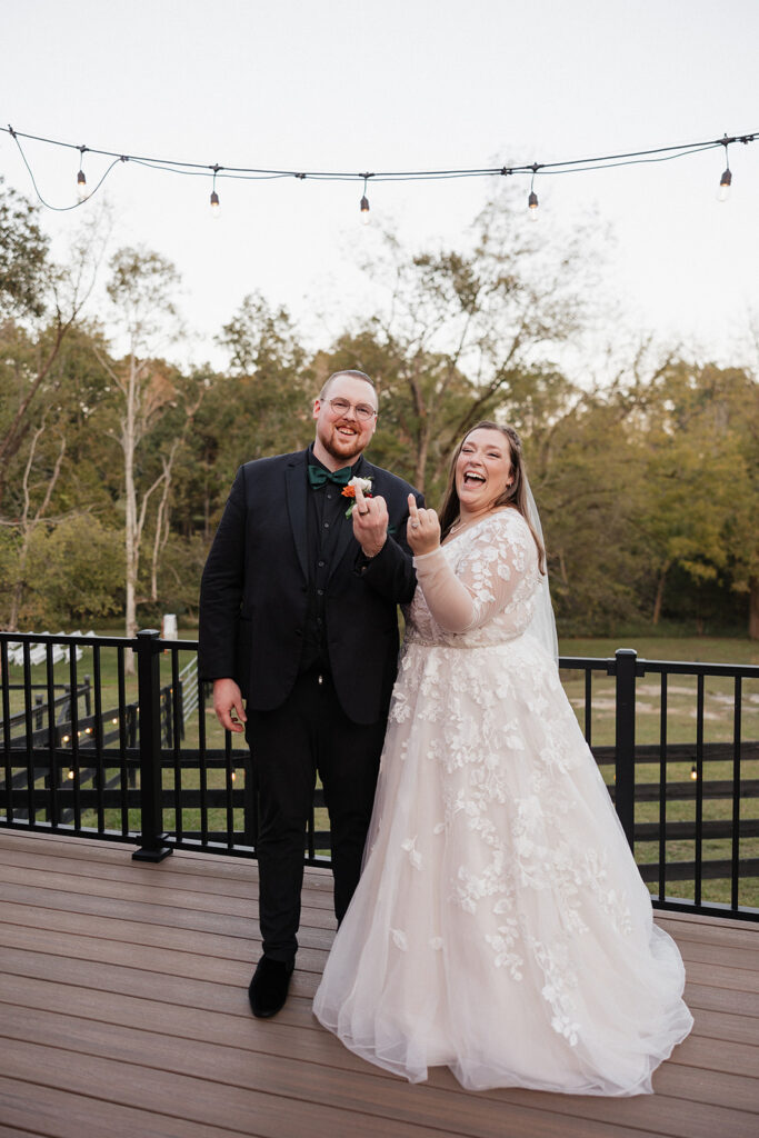 funny picture of the bride and groom showing their wedding rings