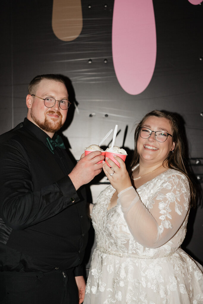 couple smiling at the camera at their reception