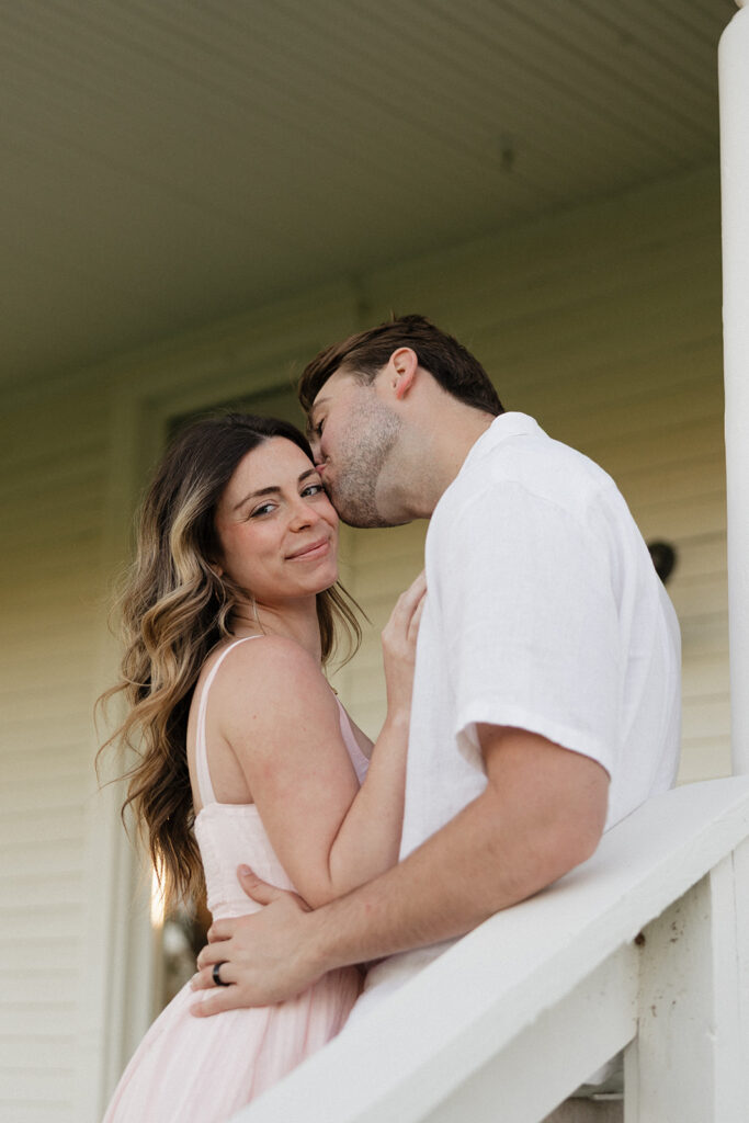 fiance kissing his fiance on the cheek