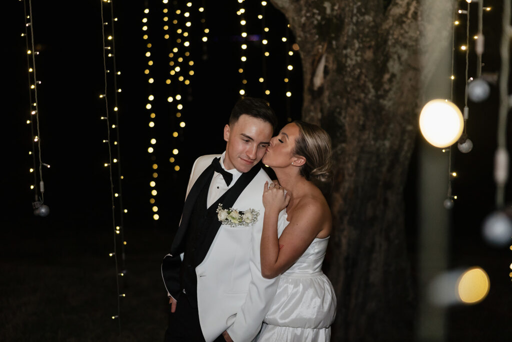 bride kissing the groom on the cheek