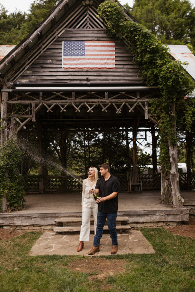couple celebrating their engagement with champagne