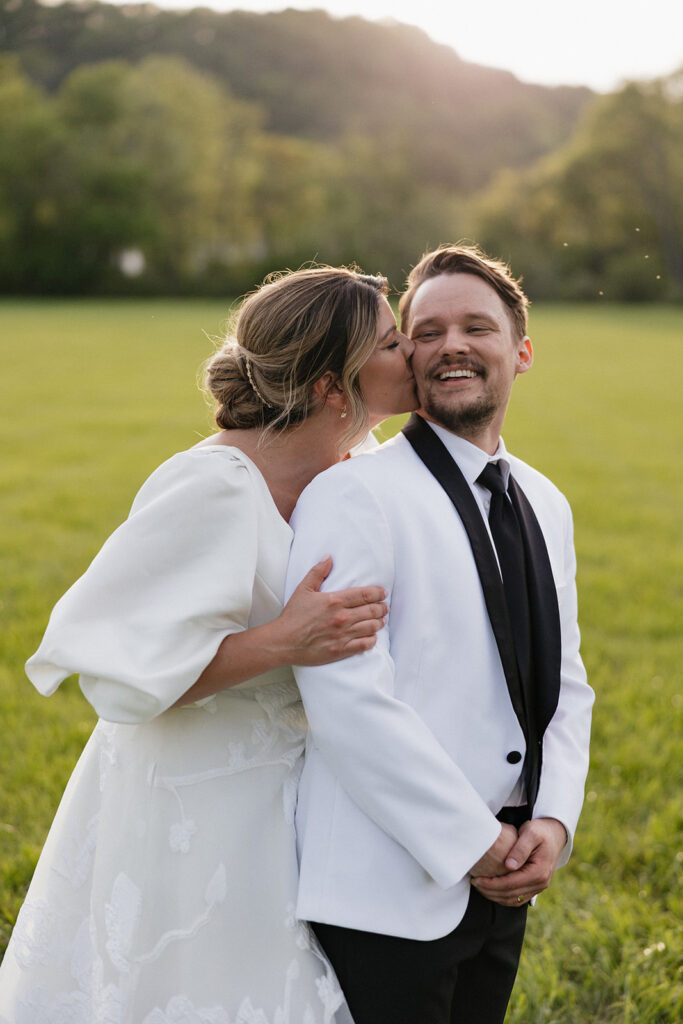 bride kissing the groom on the cheek