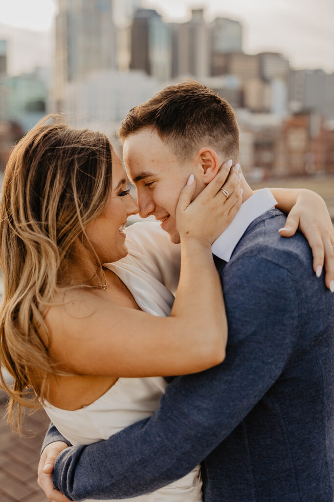 picture of the newly engaged couple smiling at each other