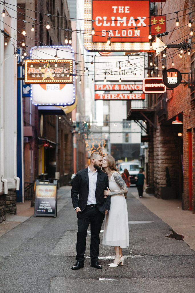 bride kissing the groom on the cheek