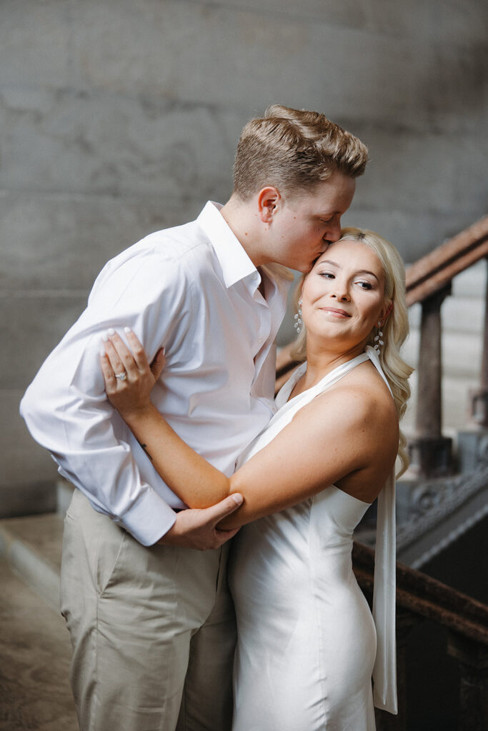 fiance kissing his fiance on the forehead