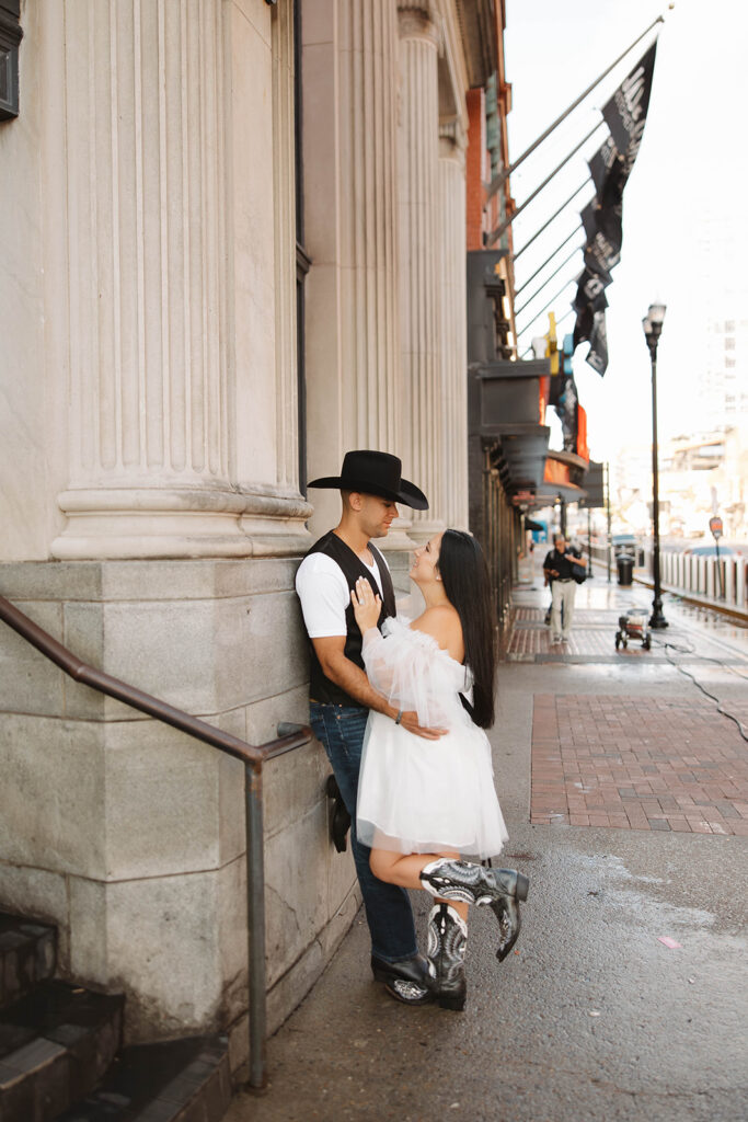picture of the newly engaged couple smiling at each other