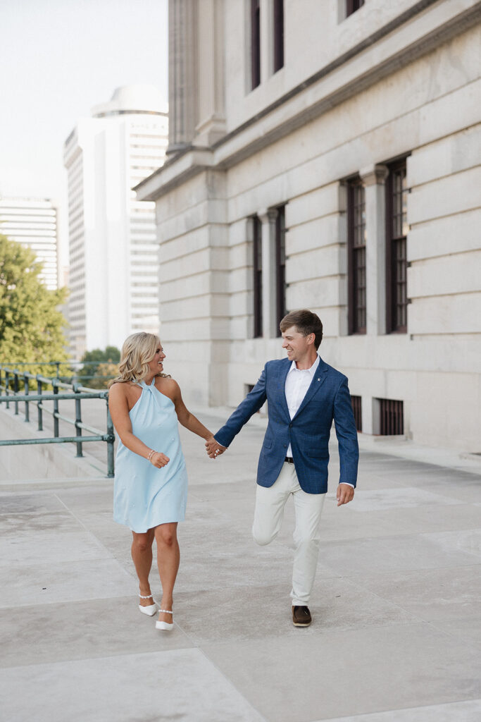 happy couple walking around their engagement session location