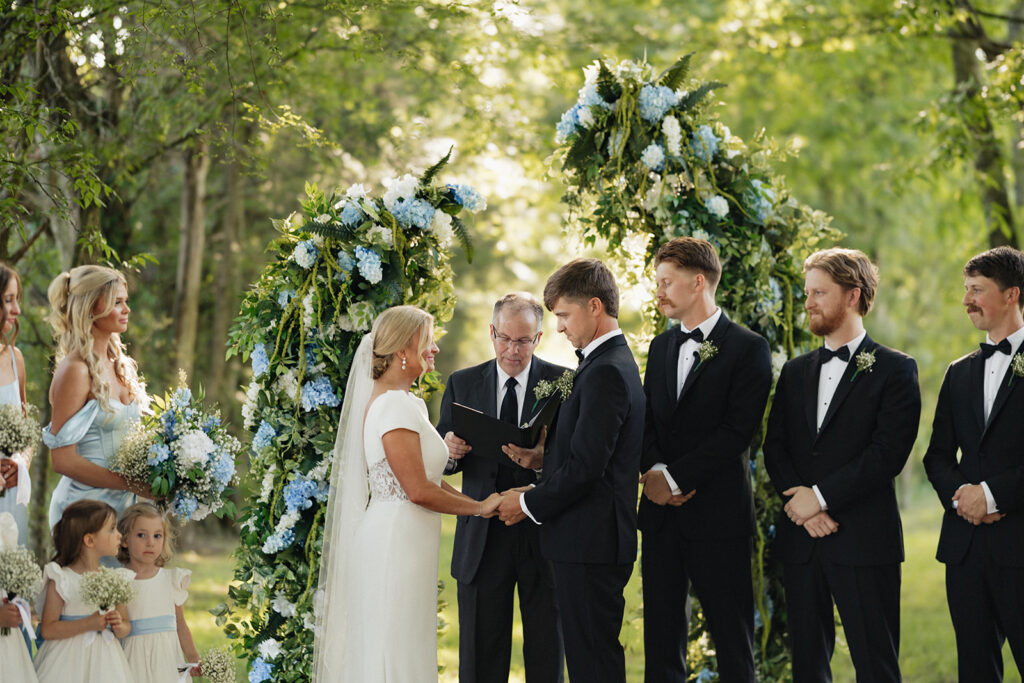 bride and groom holding hands during their wedding ceremony