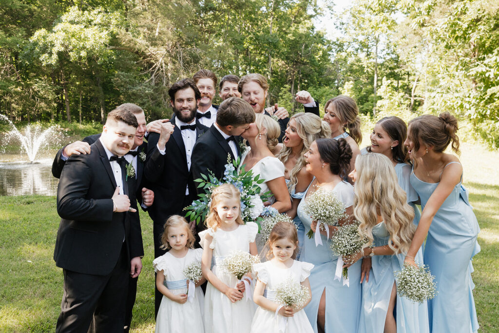 cute picture of the bride and groom kissing before heading to their ceremony