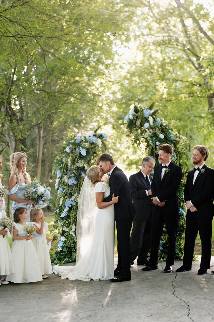 cute picture of the bride and groom kissing after their ceremony