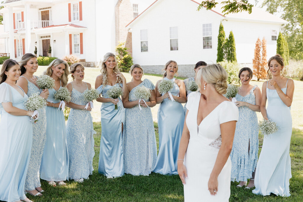 cute reaction of the bridesmaids seeing the bride in her wedding dress