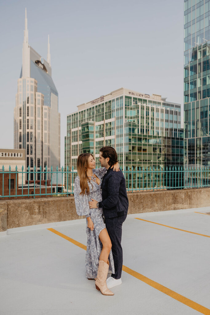 picture of the newly engaged couple smiling at each other