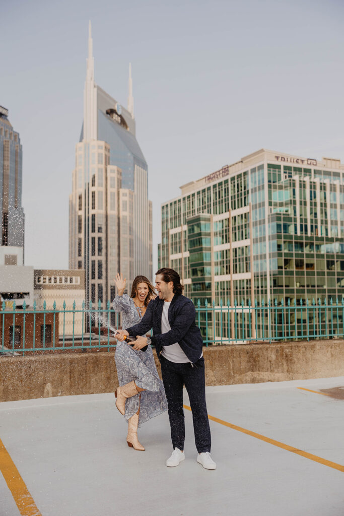 couple celebrating their engagement with champagne